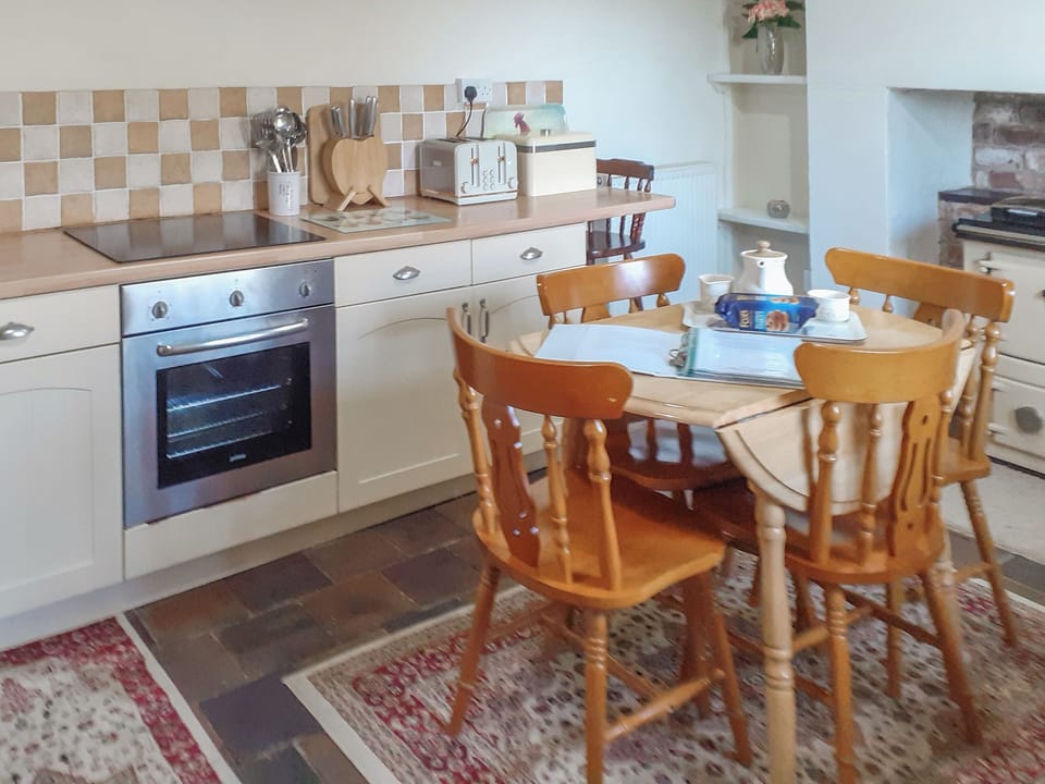 Farmhouse style kitchen with breakfast area | Bettws y Gwynt, Llanbedrgoch, near Benllech