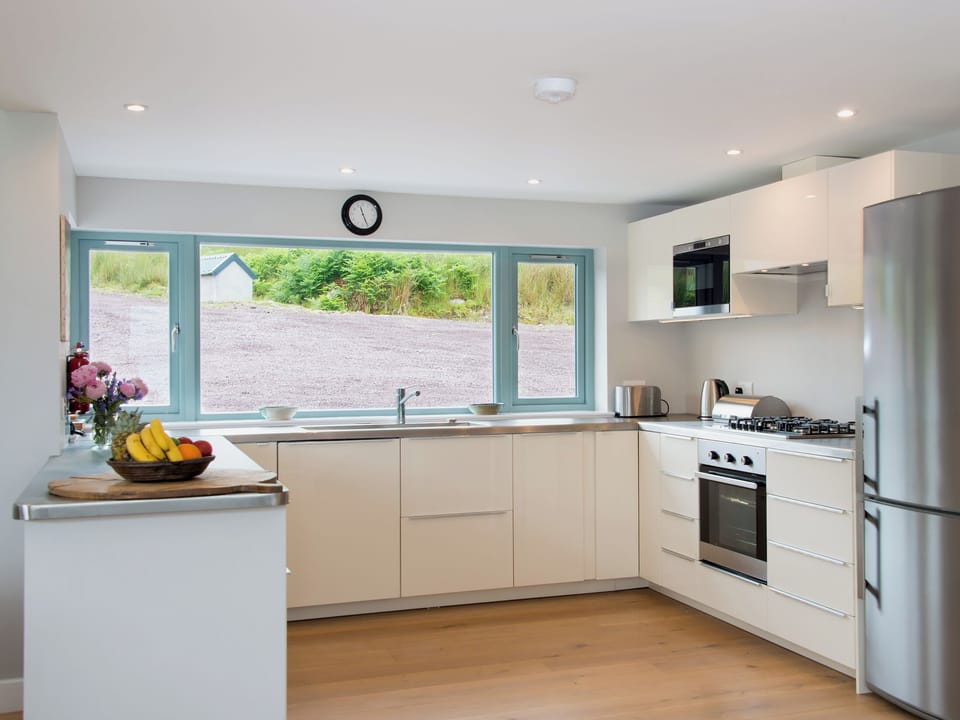 Large, well equipped (oven, microwave, fridge freezer, dishwasher) and modern kitchen with oak wooden floors. | Tigh An Iasgair, Fearnbeg, near Applecross
