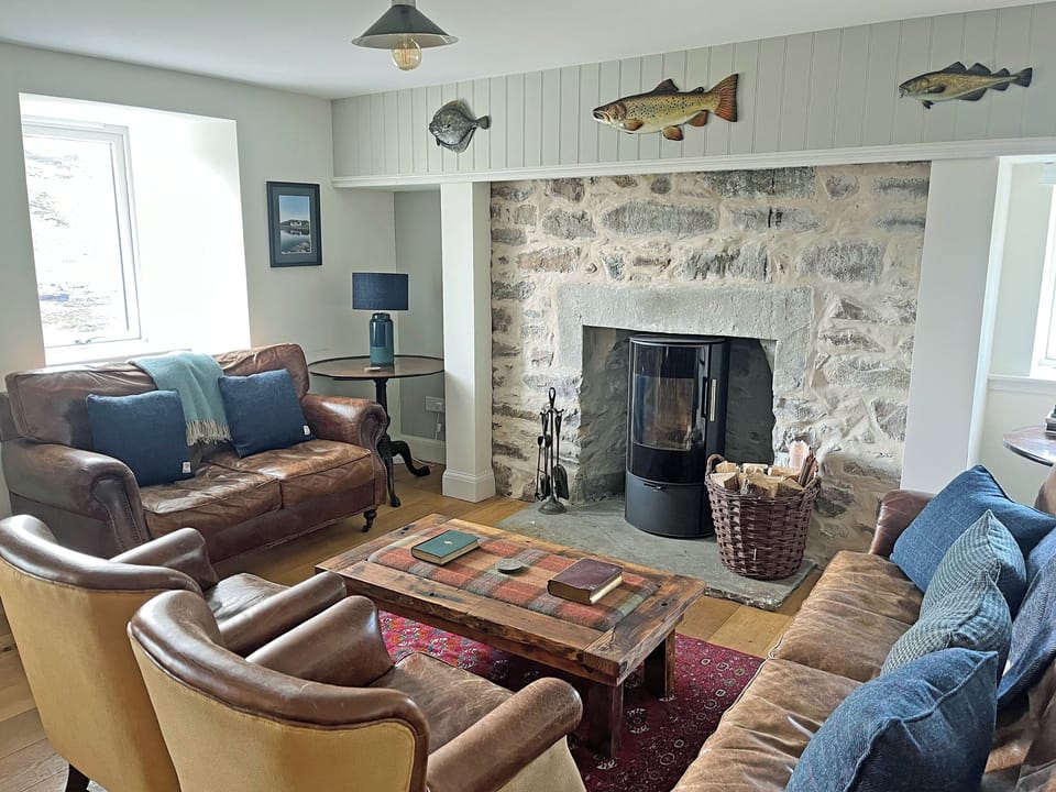 An open plan kitchendining area and living room with log burner provides a cosy nest, with a separate TV room downstairs | The Fish House - Rispond Estate, Rispond, near Durness