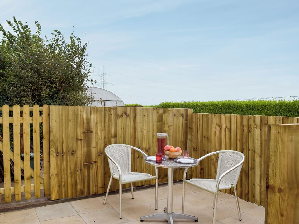 Small enclosed courtyard with patio, garden furniture and BBQ | Gardeners Lodge, near Pembroke