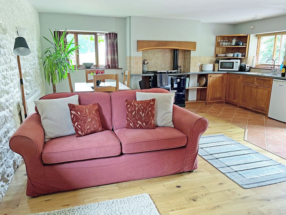Open plan living and dining area with fitted farmhouse-style kitchen area with Rayburn | Grange Farm Cottage, Spaunton, near Lastingham