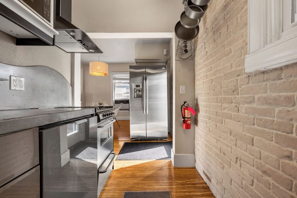 Fully stocked kitchen with custom concrete countertops, gas range, dishwasher