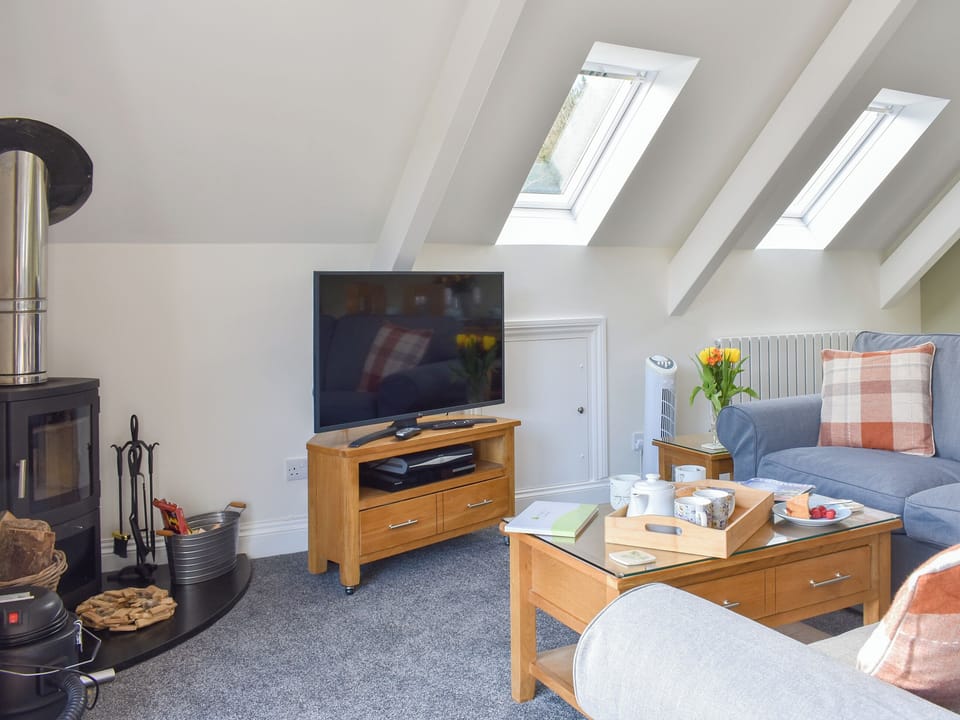 Comfy living area with wood burner | Camellia Cottage - Kilbol Country Cottages, Polmassick, near St Austell