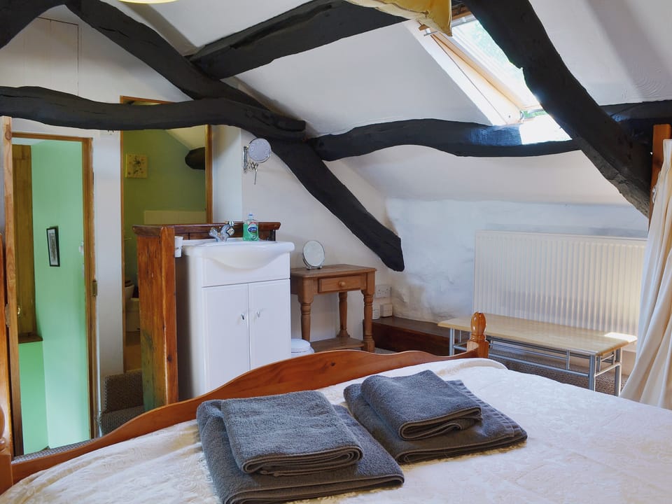 Sloping ceilings and roof lights in the delightful bedroom | The Hayloft Barn - Tyddyn Iolyn, near Criccieth