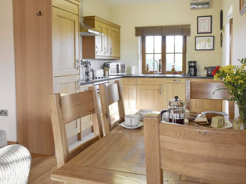 Dining area sits between living area and kitchen | Gwel-Y-Llyn - Ffynnonmeredydd Cottages, Mydroilyn, near Aberaeron
