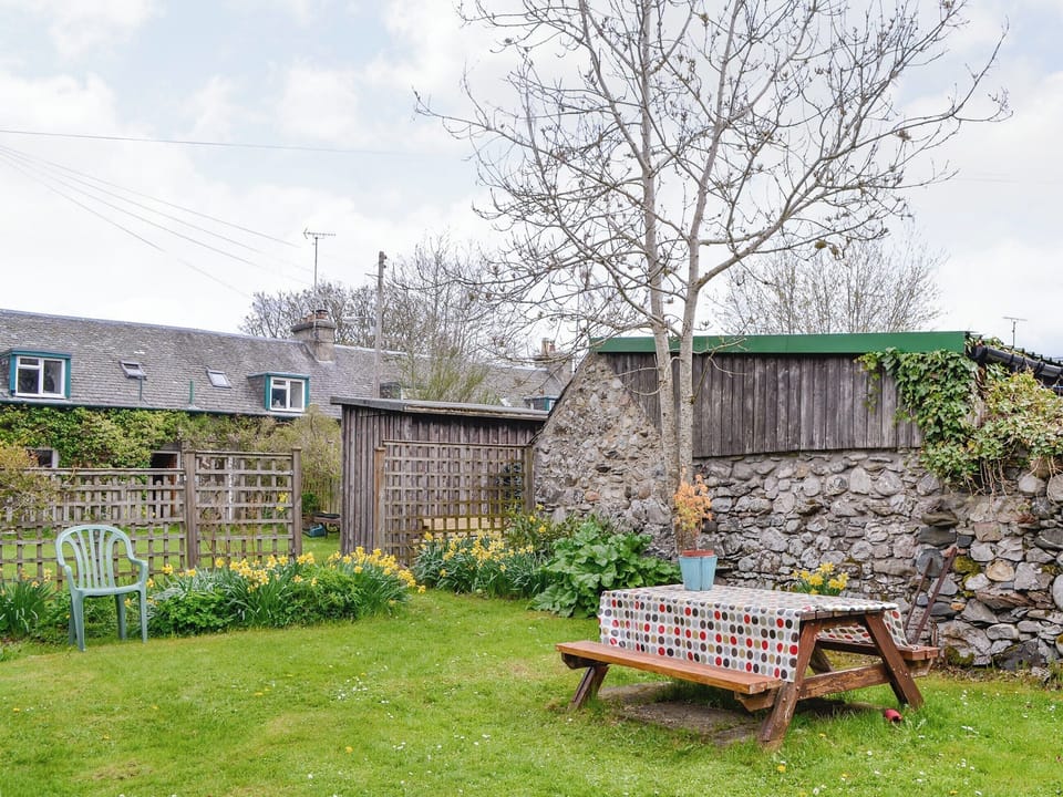Enclosed lawned garden with sitting out area | Larch Cottage, Kirkmichael, near Pitlochry