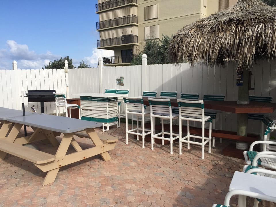 outdoor grill and picnic tables by the pool 