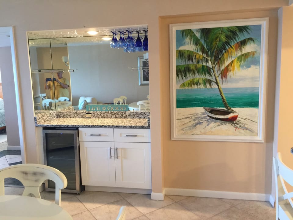 Dry Bar in Dining area with wine cooler and granite counter varitey of glasses