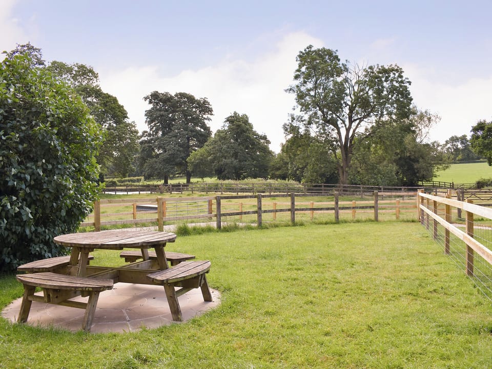 Lawned garden area with outdoor furniture on a paved patio | Churchill Cottage - Round Chimneys Farm, Glanvilles Wootton, near Sherborne