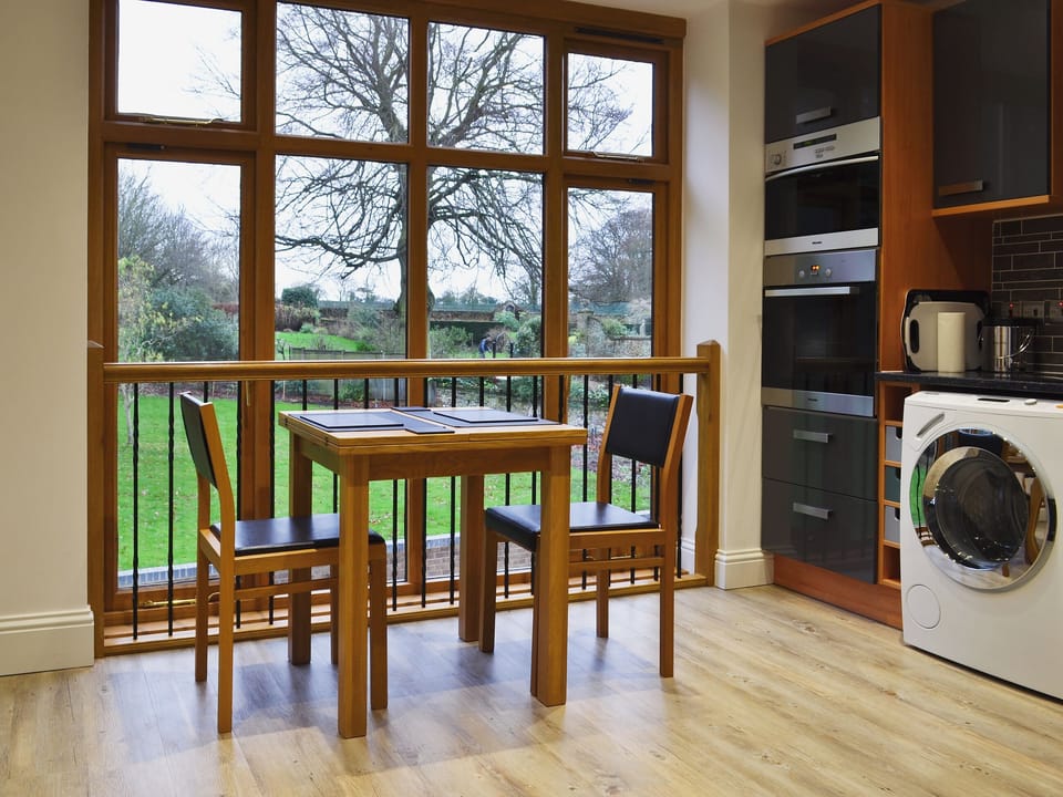 Kitchen and dining area with views of the garden | The Pump House, Old Hunstanton, near Hunstanton