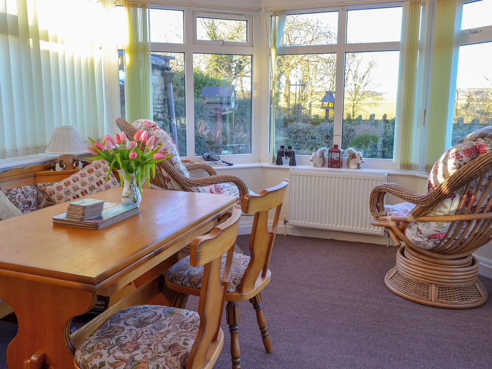 Conservatory with French doors leading to garden | Horcum View, Lockton, near Pickering