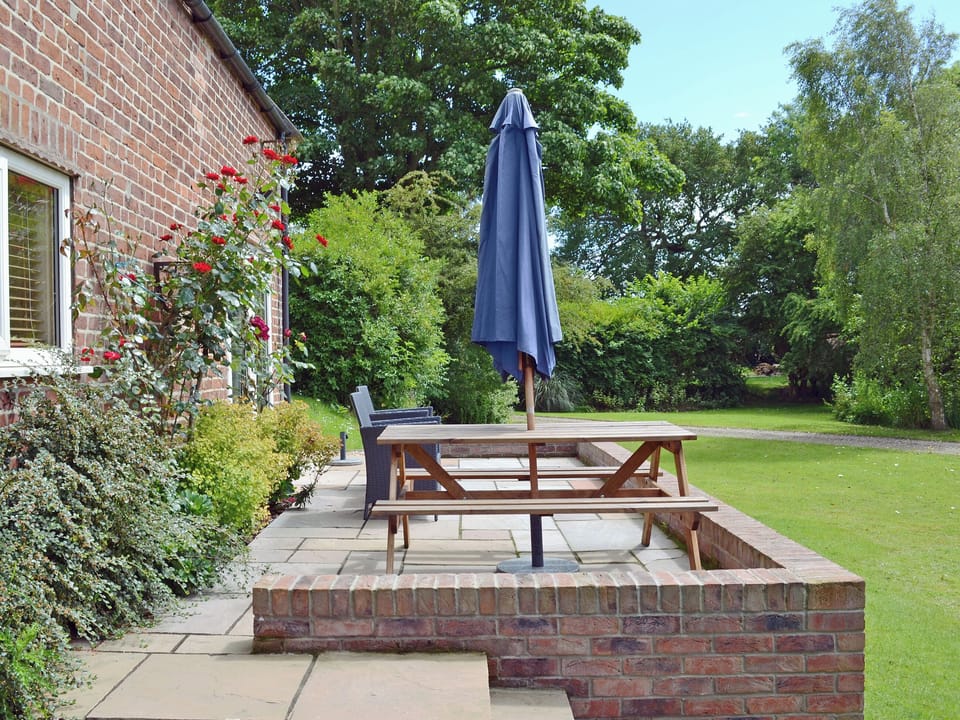Patio seating overlooking garden | The Old Coach House, Ulrome near Bridlington