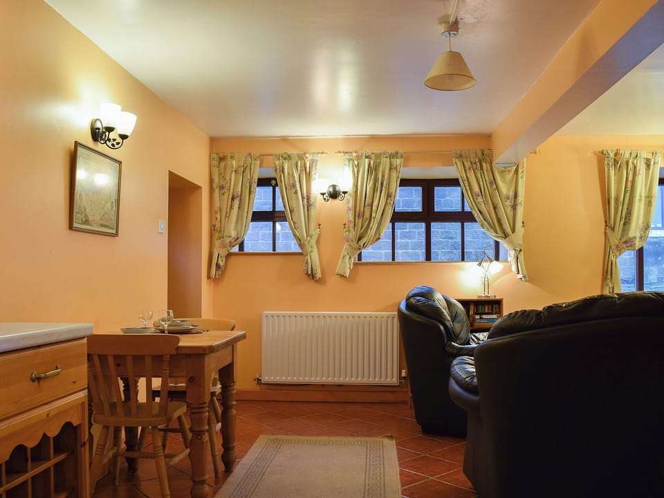 Intimate dining area and adjacent living room | The Stables - Harvey Gate Farm, Onecote