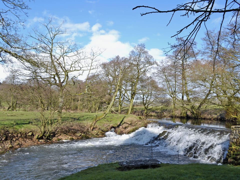 Riverside setting and surrounding Peak District countryside | The Old Mill Annexe, near Hartington