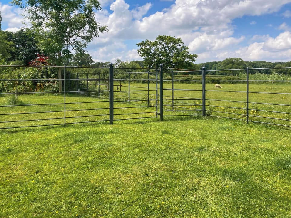 Lawned garden and far-reaching view across the open countryside | Barleycorn, Holnest, near Sherborne