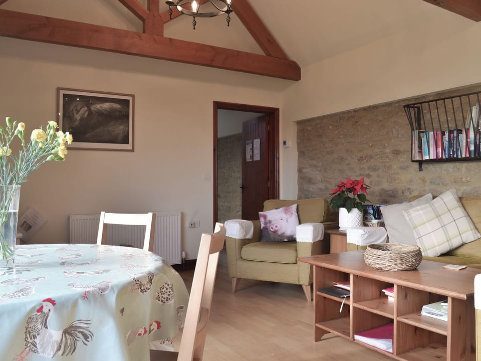 Lovely open plan living area with feature stone wall | Hog Pits - The Farm, East Tytherton, Chippenham