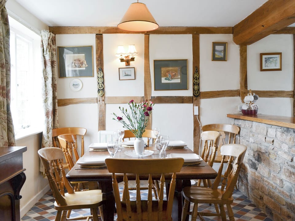 Stylish dining area with exposed wooden framework | The Old Granary, Newent, Forest of Dean