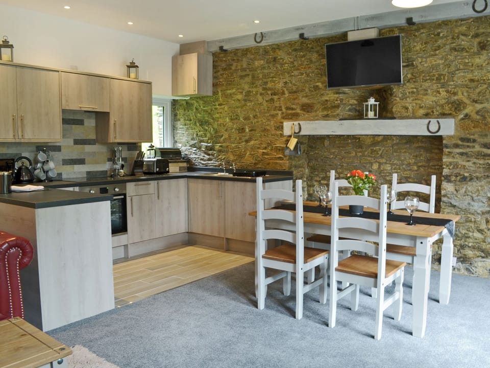 Stylishly furnished kitchen/dining area | Stable - Rosecraddoc Manor, Near Liskeard