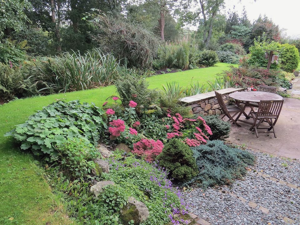 Well stocked garden with delightful table and chairs | Garries Cottage, near Bassenthwaite
