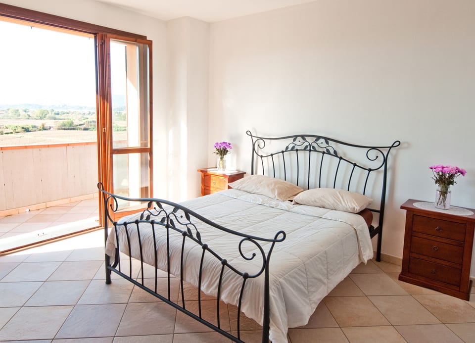 Master bedroom with a balcony and view of the valley