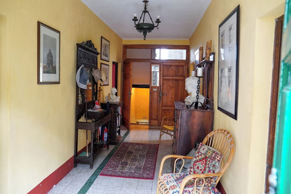 Entrance hall with door descending to garden and pool, and door to first floor