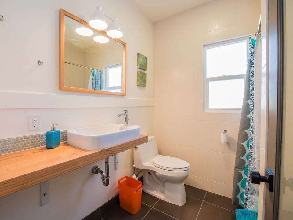 The main floor has a full bathroom with walk in shower and rain shower head.