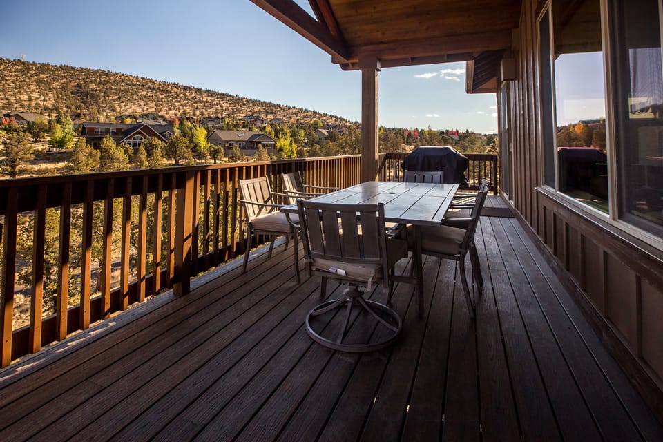 Outdoor dining area with a stainless grill and breathtaking view of Cline Butte