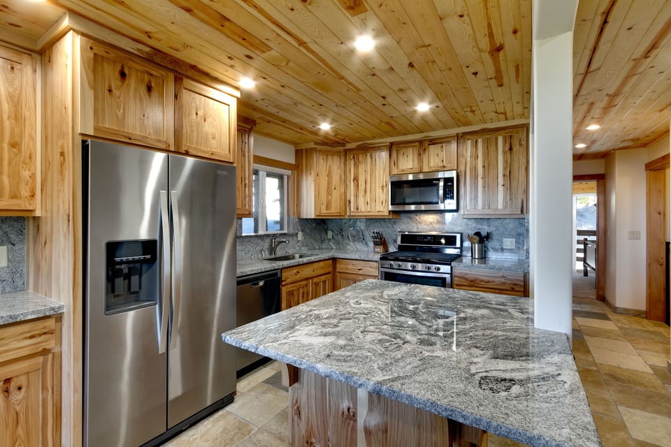 Large kitchen area with stainless steel appliances and plenty of prep space.