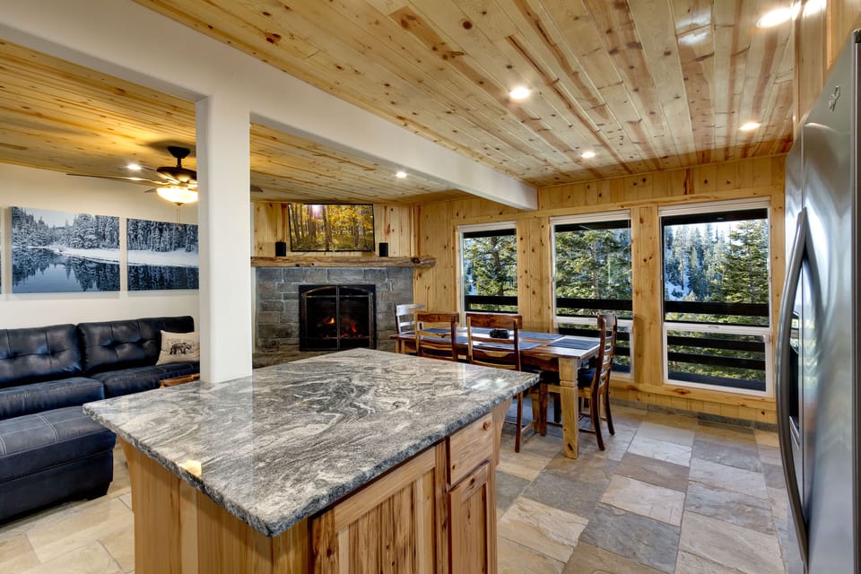 Bright and inviting dining area with scenic views of the surrounding forest and lake.