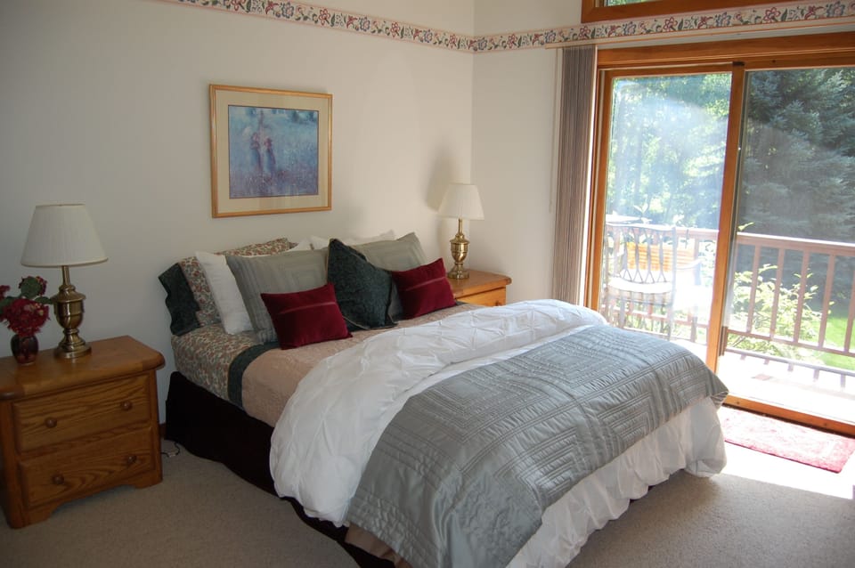 Guest bedroom with queen bed, access to hot tub.