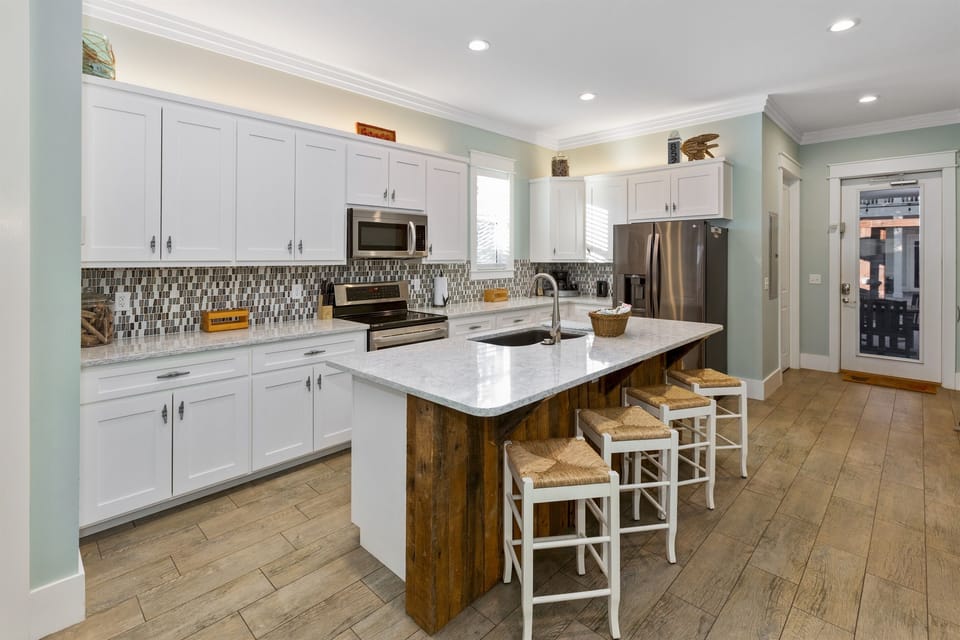 Full kitchen and direct access to the backyard, pool and grilling area.