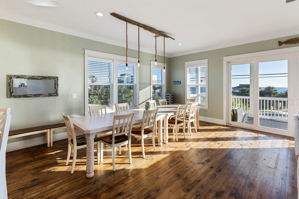 Well-lit common area on the second level includes a dining room table on the 2nd floor that seats 14. Additional seating for 7 at the island. Hotel quality furnishings on the deck offer additional space for everyone to gather and be together.