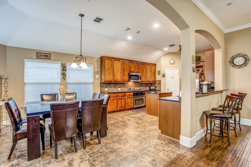 Living room is open to breakfast nook and well-stocked kitchen
