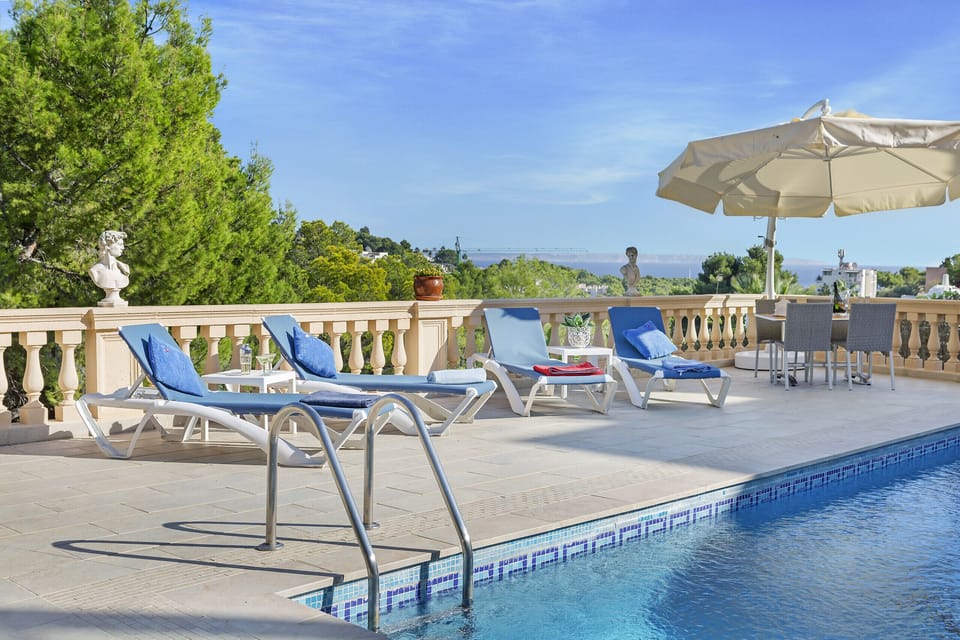 Pool with sun loungers and fabulous views at Villa Portals Nous. Come and spend your holidays in this very crowded area of Mallorca