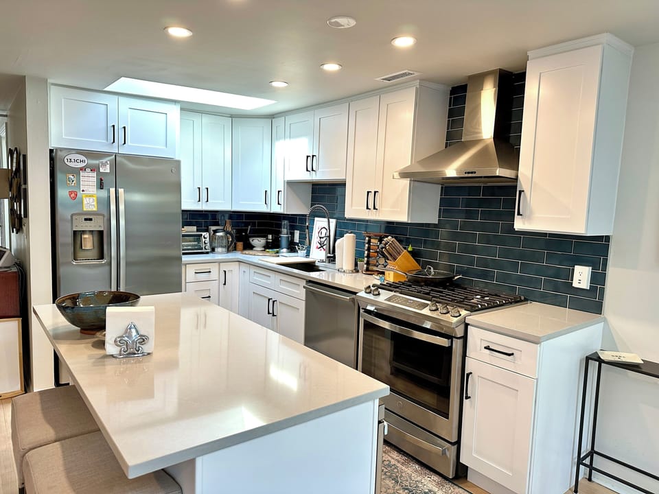 Beautiful open kitchen with stainless appliances, stone countertops, and more