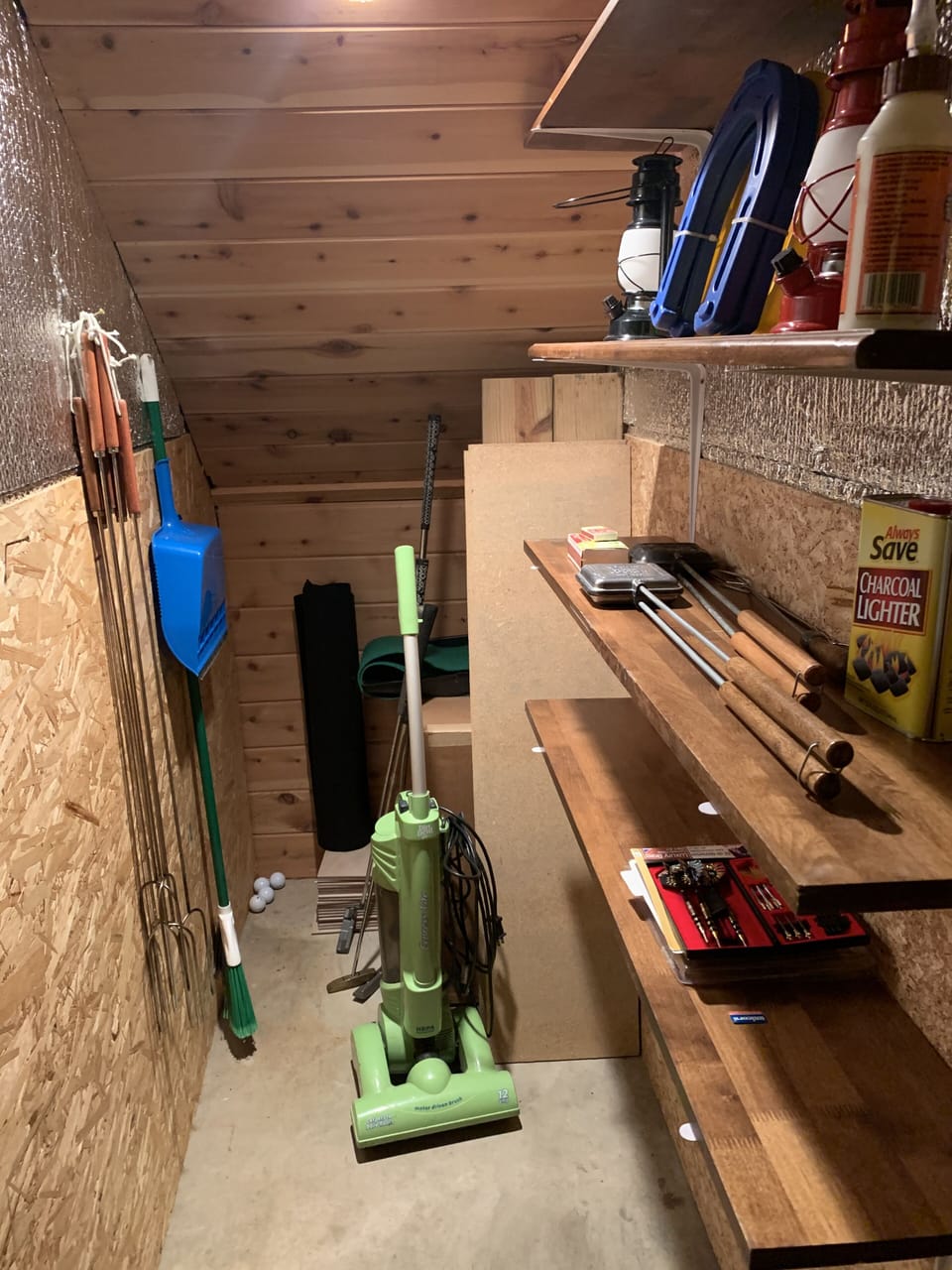 Closet w/outdoor supplies (pie irons, marshmallow forks, horseshoes, lanterns).