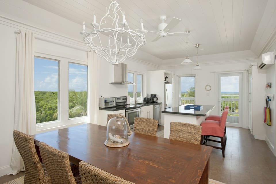 Modern kitchen in black granite and stainless steel, with views of both oceans.
