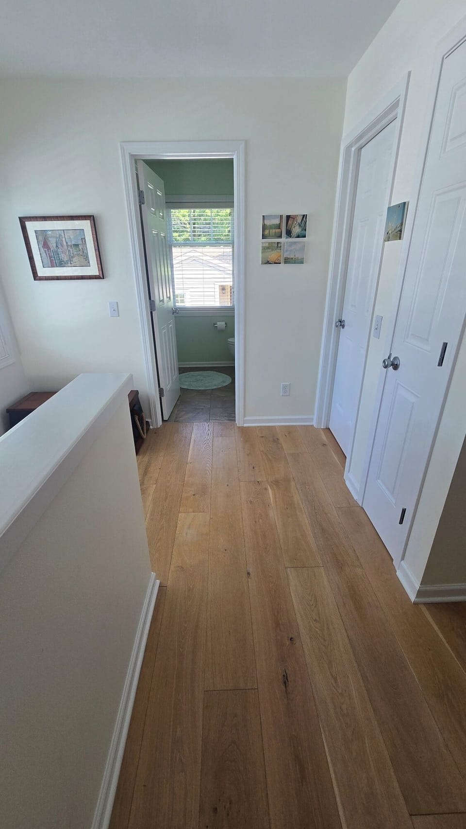 Hallway upstairs view to bathroom and door to bedroom 1