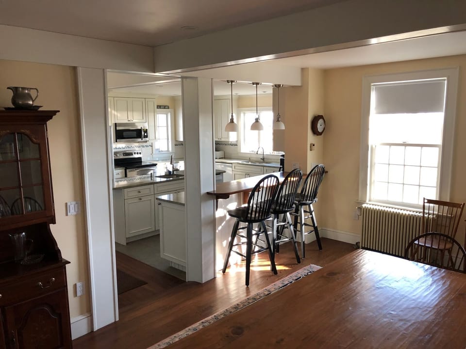View of Kitchen and bar from gathering room that seats 12.