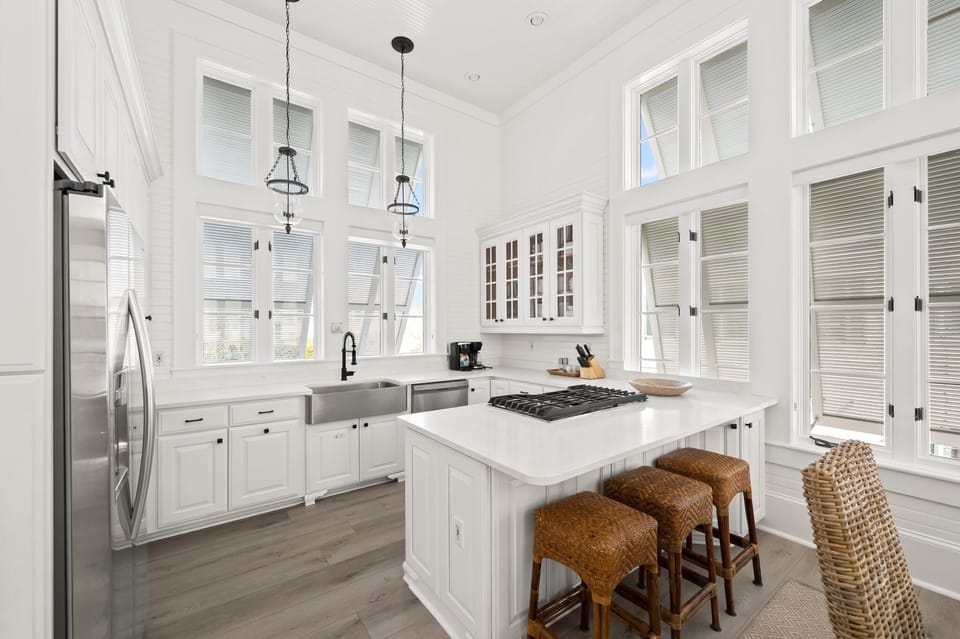 Chef's Kitchen with Natural Lighting, Luxury Quartz Island, and Soaring Double-Height Windows