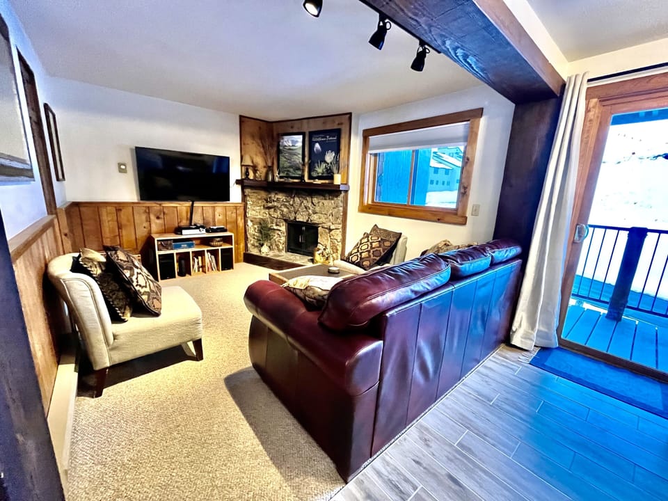 Living room with sleeper sofa, electric fireplace, cable and streaming options.