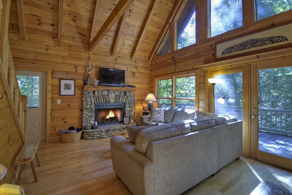 Large vaulted ceilings, comfortable seating and fireplace make this a very cozy space