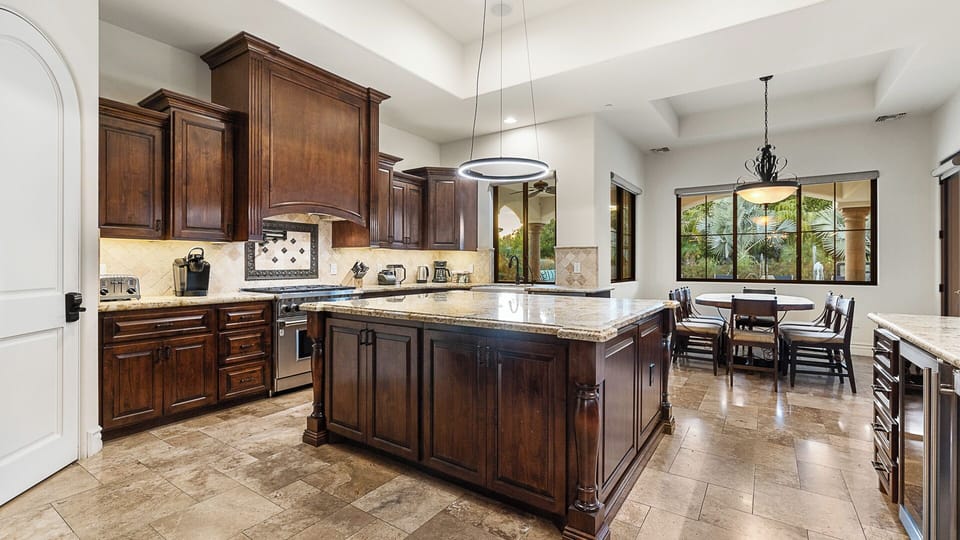 Beautiful kitchen with wood cabinetry, granite counters & spacious island!