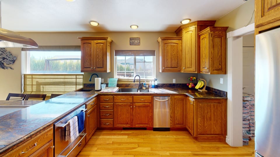 Designer chef kitchen w/ three sinks double dishwashers & granite counter tops. 