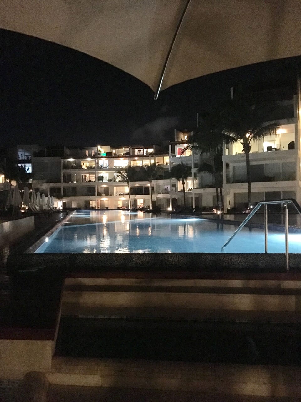 Pool at night with the condos  lit up is beautiful.
