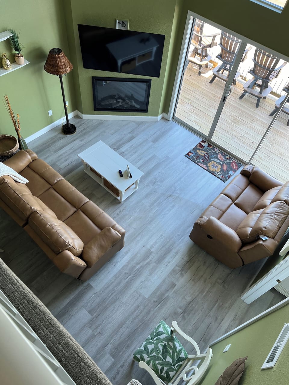 Living area looking down from the loft. Front deck looks out to the main lake.