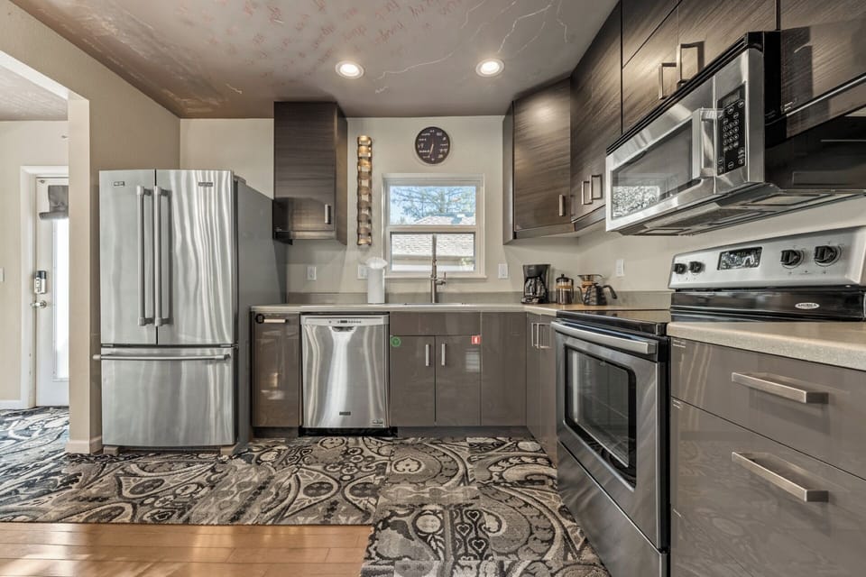 Fully stocked kitchen with electric range, dishwasher, stainless appliances