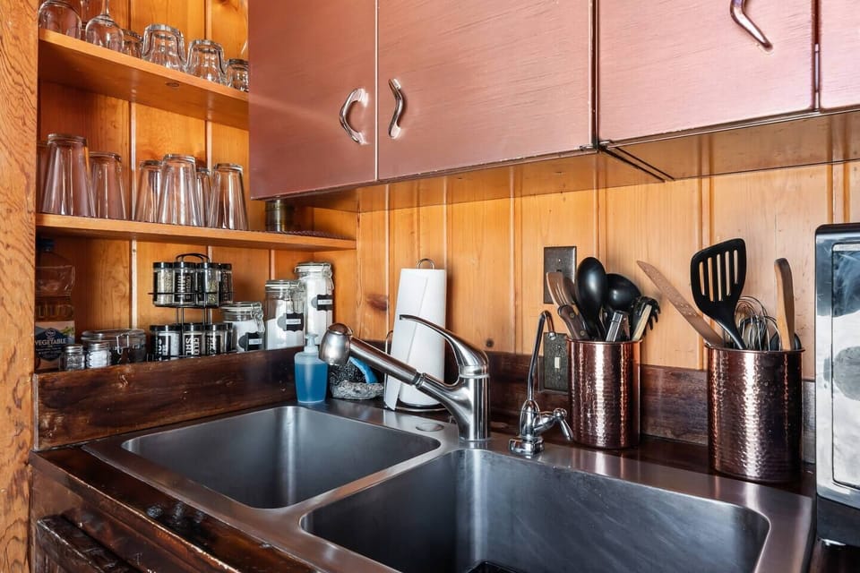 Immerse yourself in the functional charm of the kitchen area, where a well-appointed sink and organized cabinets.