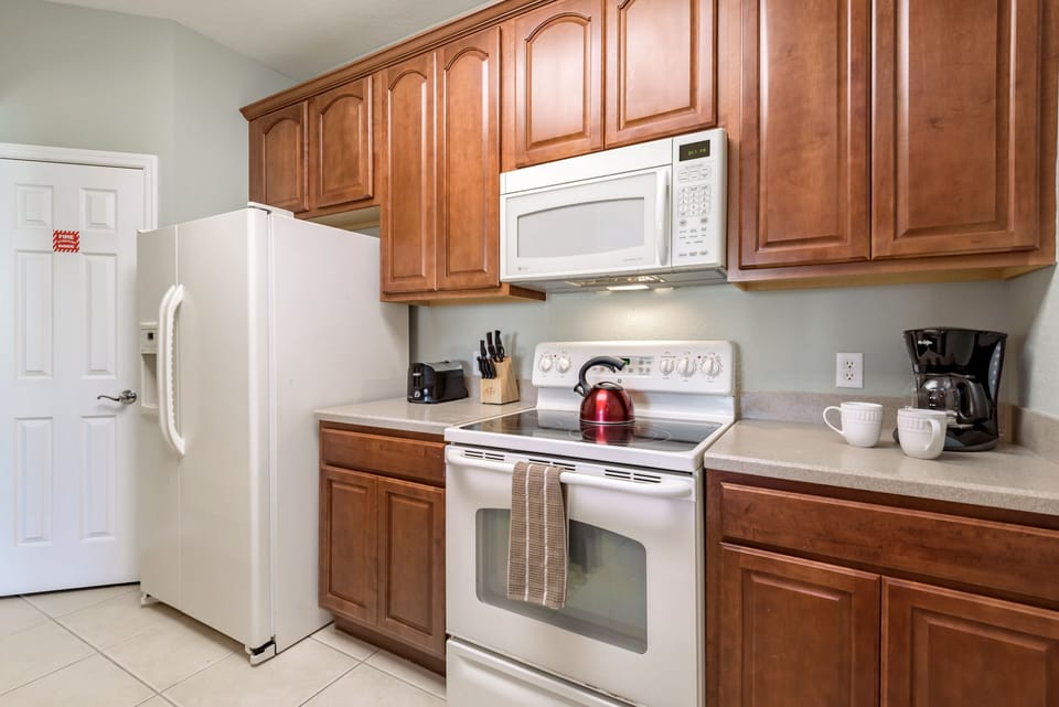 A modest yet fully functional kitchen, offering a finished look and practicality.