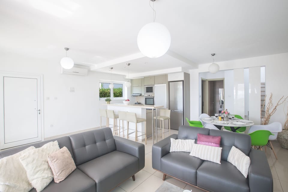 Living room with comfortable sofas, coffee table and Widescreen Satellite TV